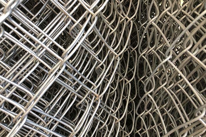 closeup of rolled chain link fence